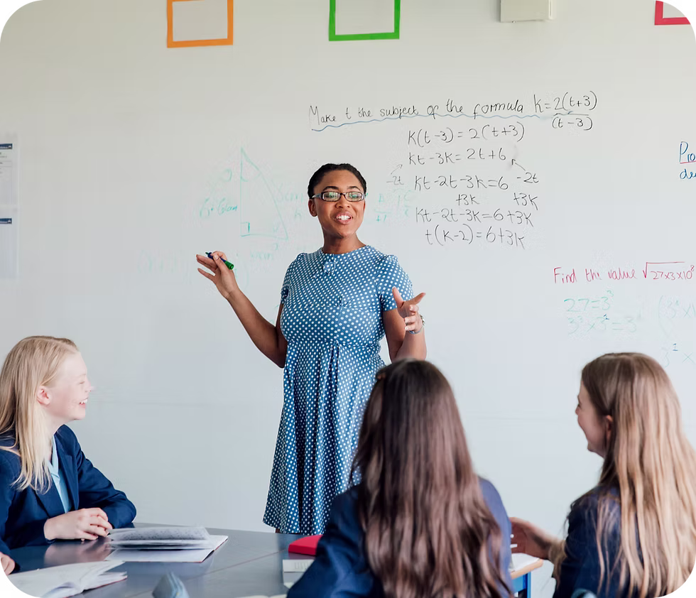 A teacher delivering a lesson at a whiteboard